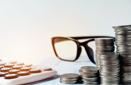 Saving money concept with money coin stack growing and calculator for business and accounting concept.の写真素材