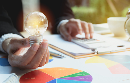 Hand of person holding light bulb for idea and success. Innovation and creative concept.の写真素材