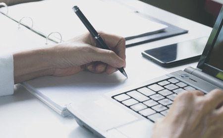 Person working and using a laptop for business and accounting concept.の写真素材