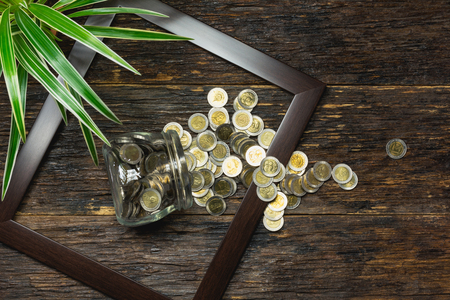 Top view of stack of coin in the frame accounting concept on wooden background.の写真素材