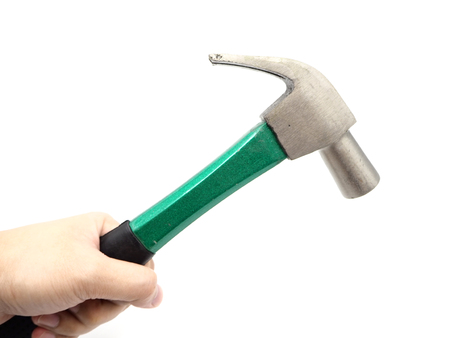 Hand holding a green iron hammer with rubberized handle isolated on a white background.の写真素材