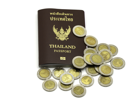 Passport cover of Thailand, Identification citizen with coins isolated on white background.の写真素材