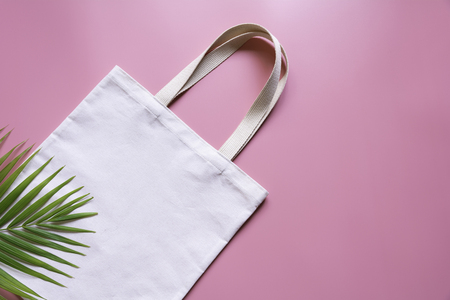 White tote bag canvas fabric. Cloth shopping sack mockup with copy space.の写真素材
