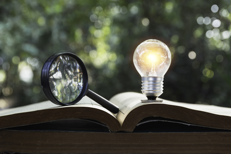 Light bulb and pile of book on table and copy space for insert text.の写真素材