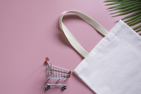 White tote bag canvas fabric and chopping cart. Cloth shopping sack mockup with copy space.の写真素材