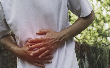 Male suffering from stomachache pain. A man stomachache at outdoor,Healthy concept.の写真素材