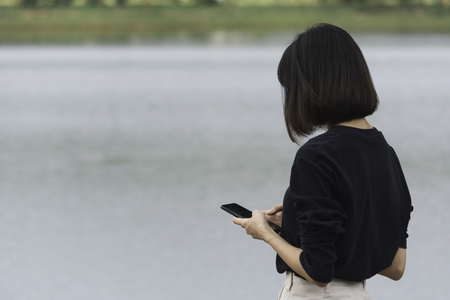 Young woman using a smart phone with copy space for insert text.の写真素材
