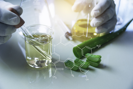 Researcher with glass laboratory chemical test tubes with liquid for analytical , medical, pharmaceutical and scientific research concept.の写真素材