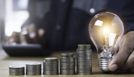 Hand of male holding a light bulb and copy space for accounting, ideas and creative concept.の写真素材