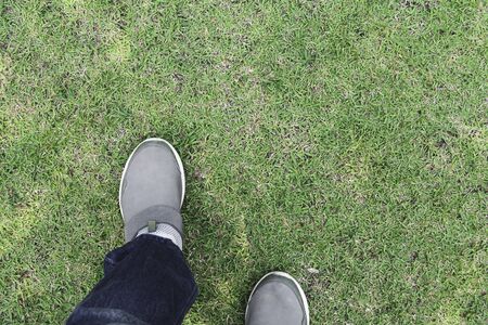A man walking at the grass field, Top view and out side lifestyle concept.の写真素材