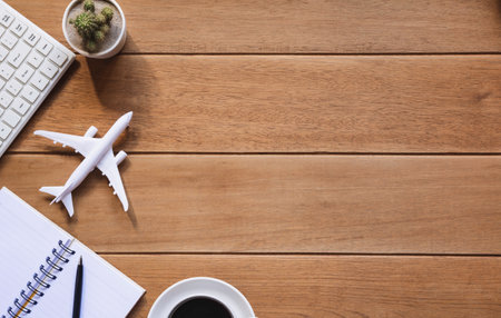 Top view of pen with other supplies, keyboard and notebook on wooden table and copy space for insert text.の写真素材