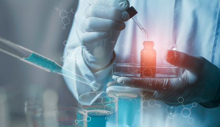 Researcher with glass laboratory chemical test tubes with liquid for scientific researchの写真素材