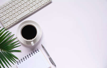 Top view of coffee with other supplies and keyboard on white background and copy space for insert text.の写真素材