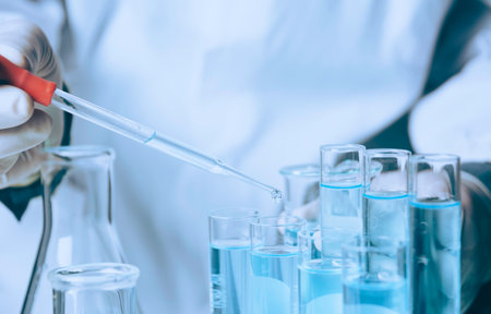 Researcher with glass laboratory chemical test tubes with liquid for analytical , medical, pharmaceutical and scientific research concept.の写真素材