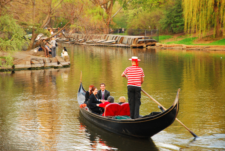 Couples enjoy a romantic gondola ride on a lake in New York's Central Parkのeditorial素材