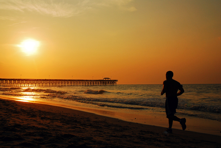 A Jogger Runs Along the Shore at Myrtle Beachのeditorial素材