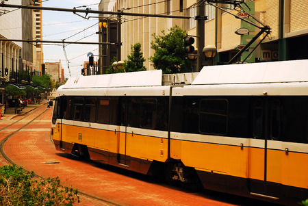 A DART Light Rail Train Plies Through Downtown Dallas Texasのeditorial素材