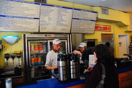 An adult woman places her order at a Greenwich Village cafe that specializes in peanut butterのeditorial素材
