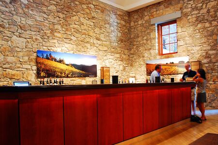 Two adults relax at a wine tasting at a winery in the Napa Valleyのeditorial素材
