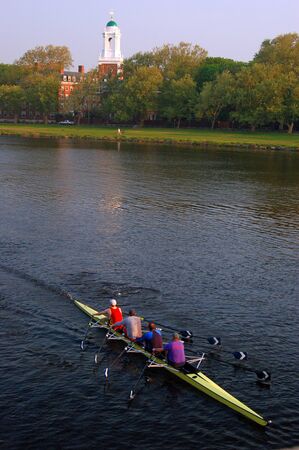 A crew team plies the Charles River near Harvard Universityのeditorial素材