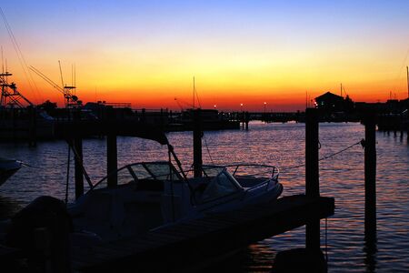 Sunset lends a peaceful aura to a small marinaの写真素材