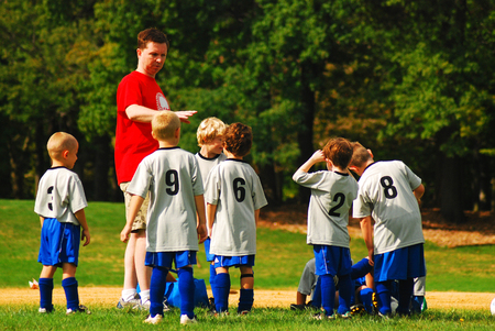 A coach assigns positions at a youth soccer gameのeditorial素材