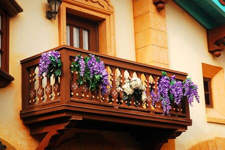 Flowers adorn a fairy tale like balconyの写真素材