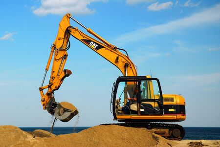Heavy machinery is employeed to repair beach erosion in New Hampshireのeditorial素材