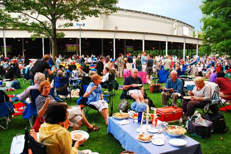 Friends enjoy an al fresco dinner at the Tanglewood Theater in the Berkshire Mountains of Massachusettsのeditorial素材