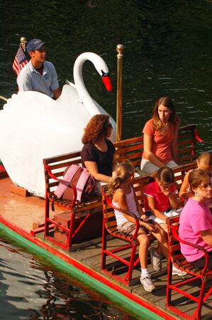 Families enjoy a ride on Boston's iconic Swan Boatsのeditorial素材