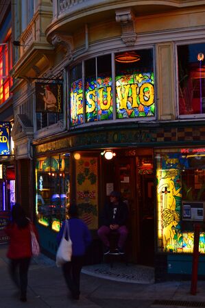 Folks wander past Vesuvio Tavern, a popular haunt of Jack Kerouac and Allen Ginsburg, in San Franciscoのeditorial素材