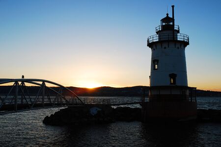 The sun sets behind the Tarrytown Lighthouseの写真素材