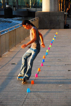 Battery Park Roller Blader glides through cups in a park, New York City