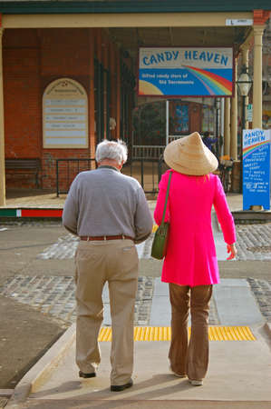 An elderly couple takes a walk through the historic Old Sacramento neighborhoodのeditorial素材
