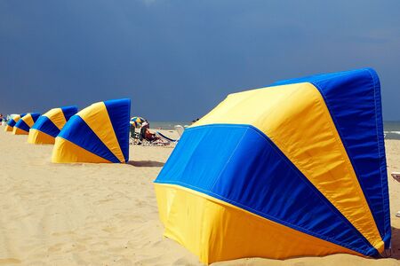Beach huts stand ready to guard against an approaching storm in Virginia Beachの写真素材
