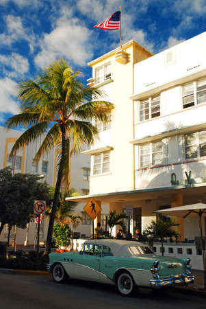 A green and white classic Buick Special is parked in front of the Avalon hotel in South Beach, Miami Beachのeditorial素材