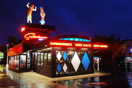 Two large Hot dogs stand atop Superdawg, one of Chicago's legendary hot dog standのeditorial素材