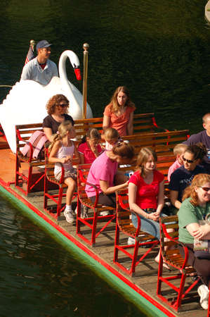 Riders Enjoy a Leisurely Cruise on the Iconic Swan Boats in Boston's Public Gardenのeditorial素材