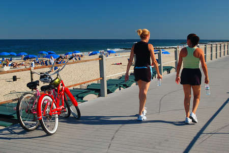 Two young adult women enjoy a summer stroll on the Boardwalk on the Jersey Shoreのeditorial素材