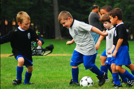 Young boys engage in fierce competition at a youth soccer gameのeditorial素材