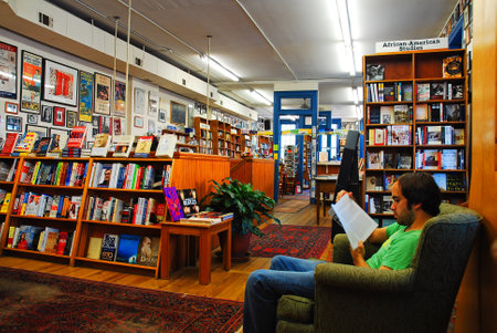 A young man reads at Square Books, a famed independent bookseller in Oxford, Mississippiのeditorial素材