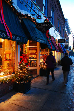 Two shoppers stroll downtown Woodstock, Vermont, seeking their Christmas giftsのeditorial素材
