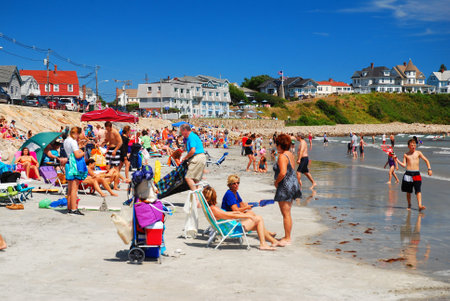 A crowd relaxes on the narrow beach in York, Maineのeditorial素材