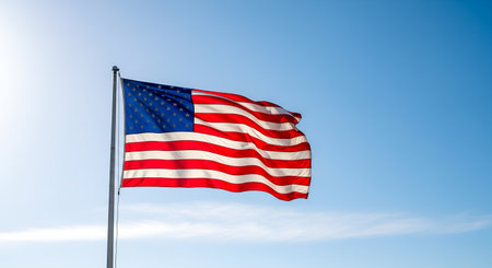 Stars stripes glory fluttering against bright sky signifying American pride patriotism liberty freedom independence national symbol governmental representation United States American values identity American flag represents ideals aspirations country its people democracy justiceの素材