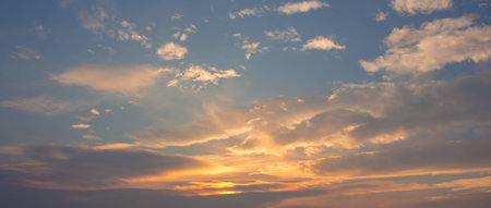 Blue sky with orange, puffy clouds