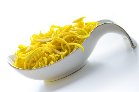 lemon zestl on a plate on white backgroundの写真素材
