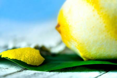 peeled lemon and zest  on green leaf closeupの写真素材