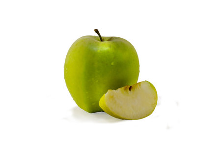 The piece of green cutted apple with the appleの写真素材