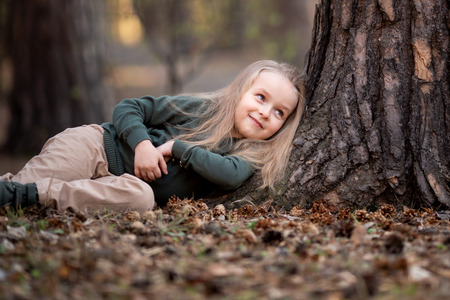 Girl is lying under the tree in the parkの写真素材