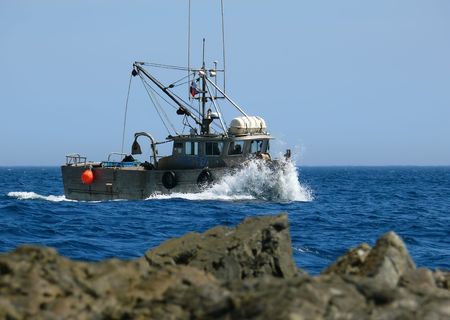 A small fishing motor boat on stormy sea. Russian Far East, Japanese sea, Primorye.の写真素材